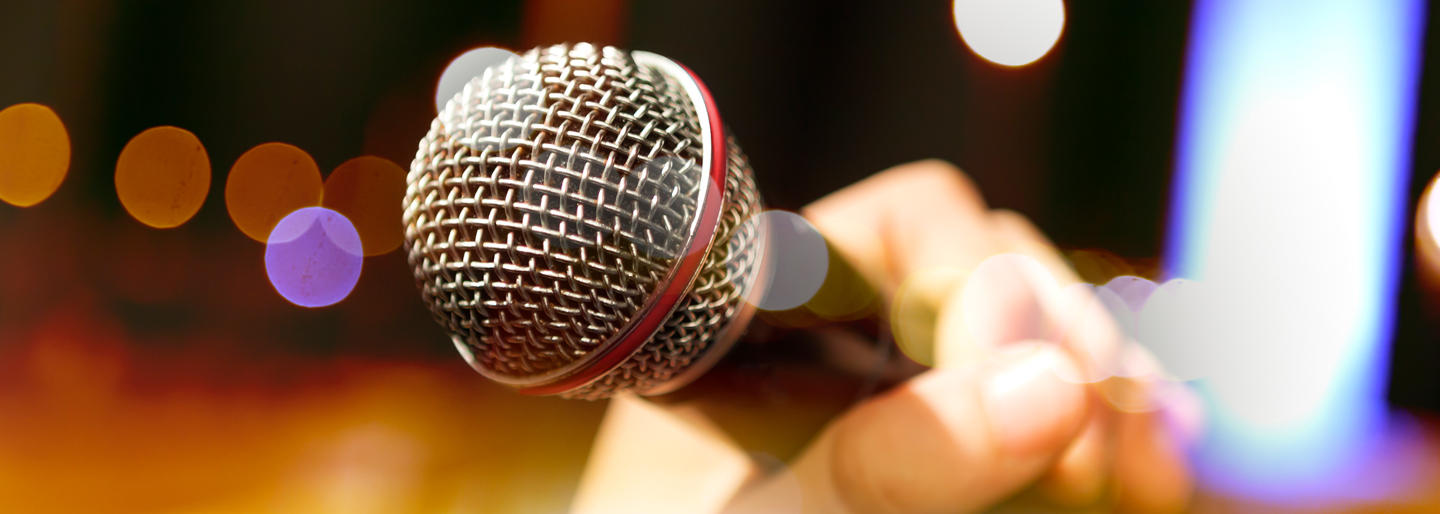Image of a hand holding a microphone