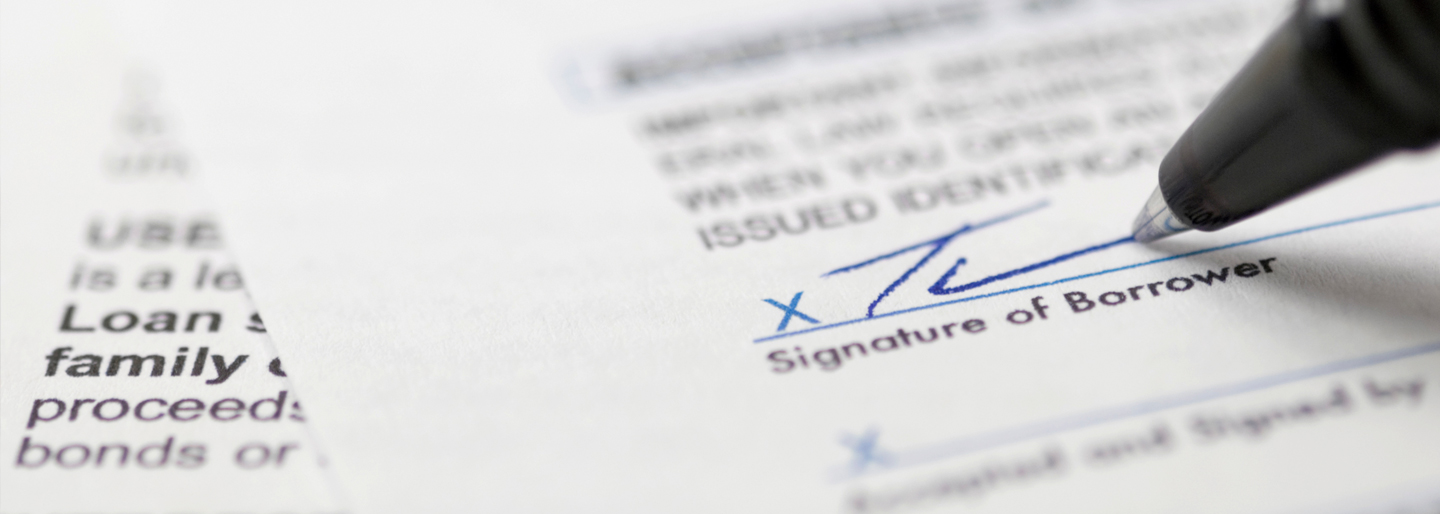 Pen with signature signing loan documents