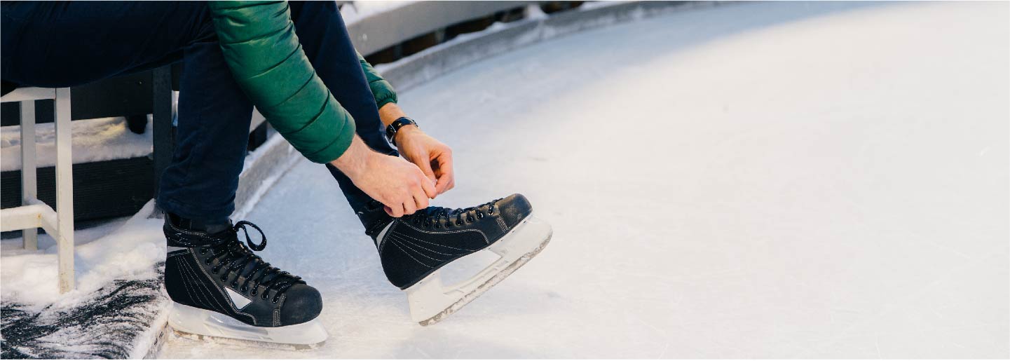 Person lacing up ice skates