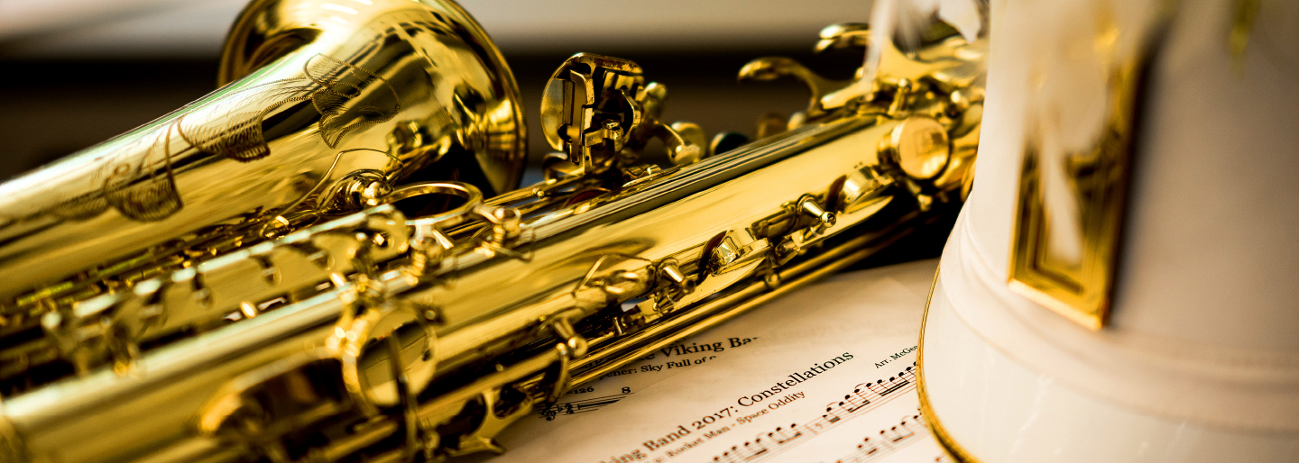 Saxophone laying on its side with music notes