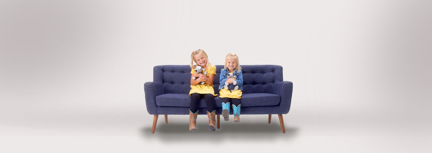 Girls sitting on blue couch