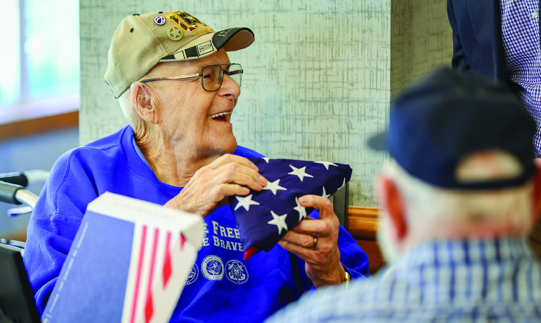 Homestead of Manhattan Assisted Living flag presentation.