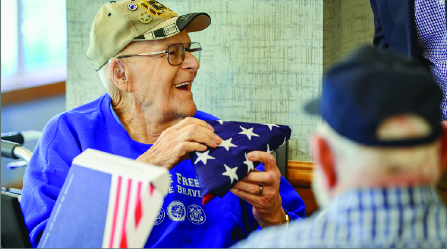 Man receiving flag.
