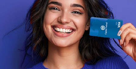Woman smiling and holding a Capitol Federal Visa card