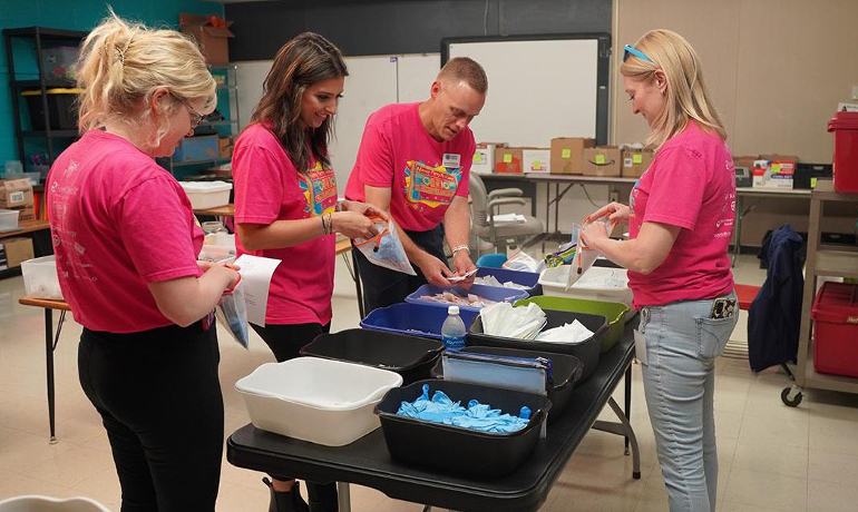 Volunteers packing donation kits.