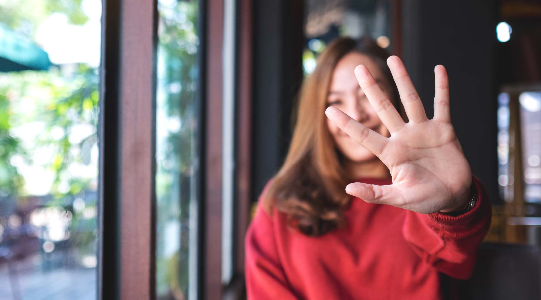 Woman holding up a five with her hand