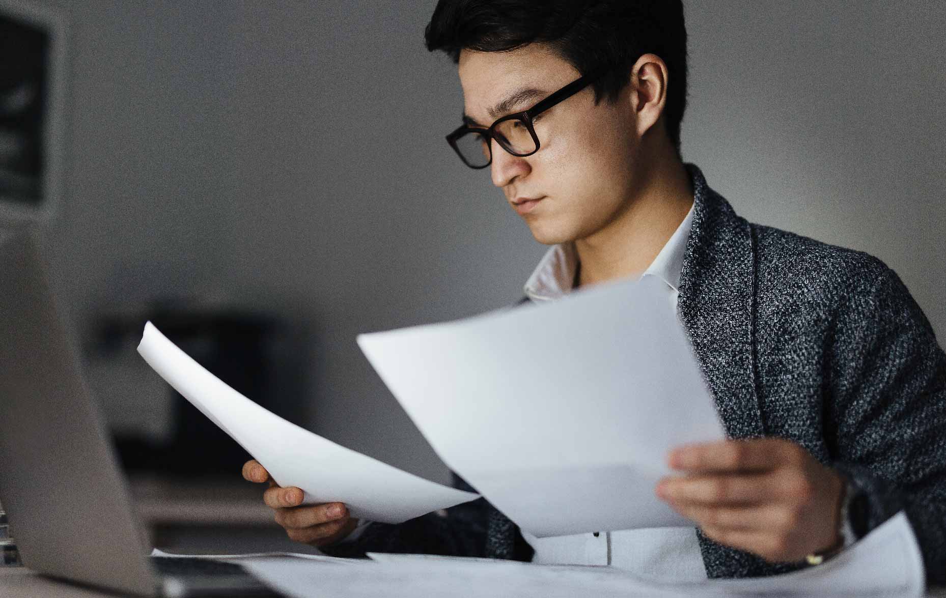 Man looking at tax documents.